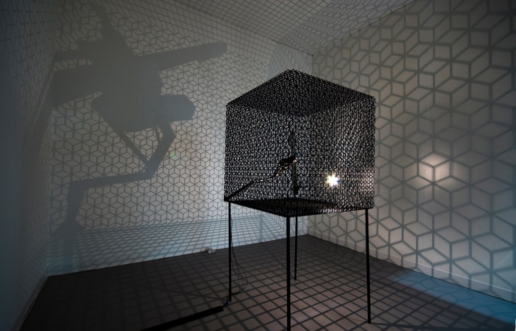 Conrad Shawcross, 'Slow Arc Inside a Cube IV', 2009. Steel mesh, mechanical system, light. 120 x 120 x 180 cm. Courtesy the artist and Victoria Miro, London